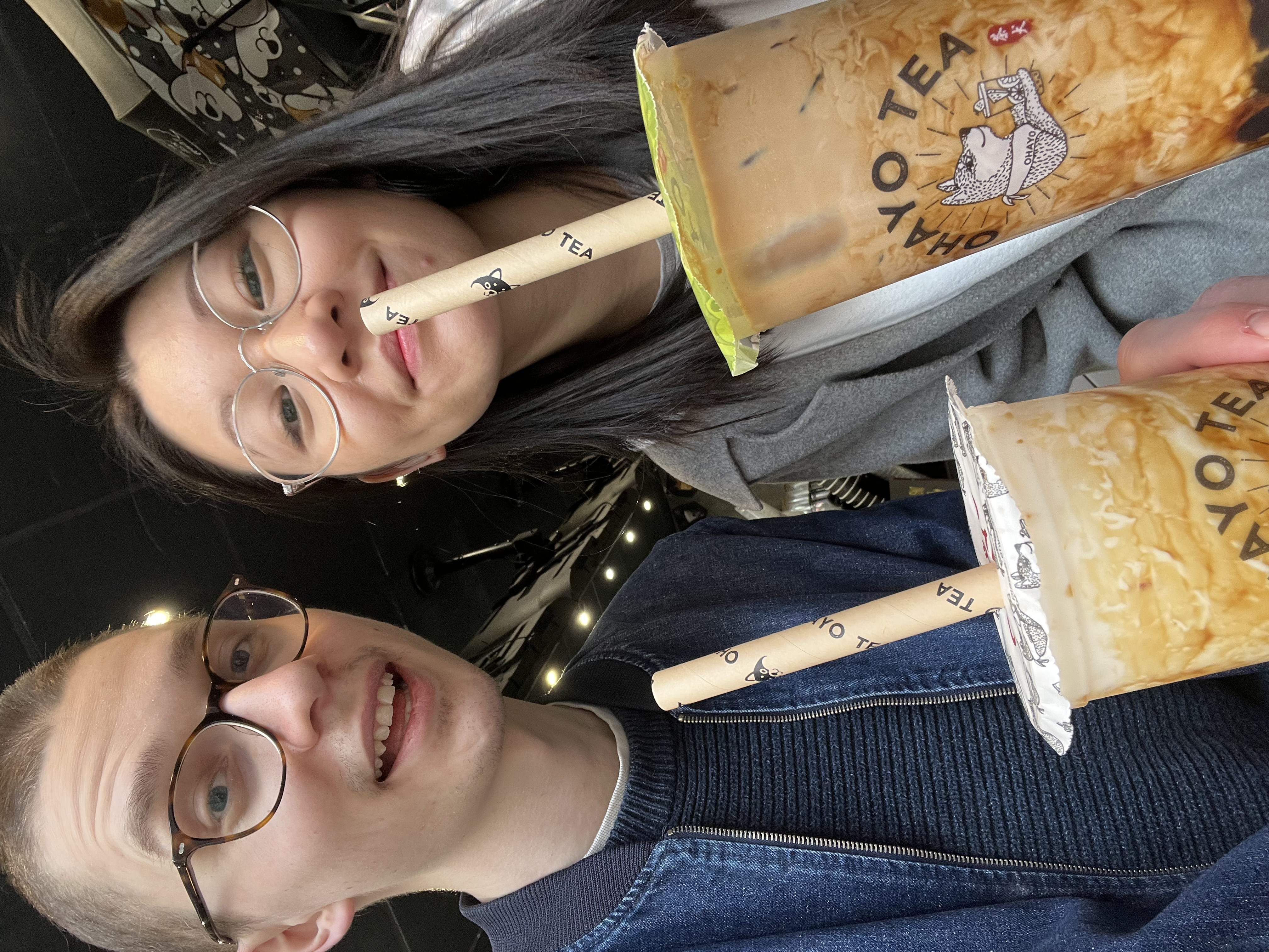 Charlie and Thila holding cups of bubble tea